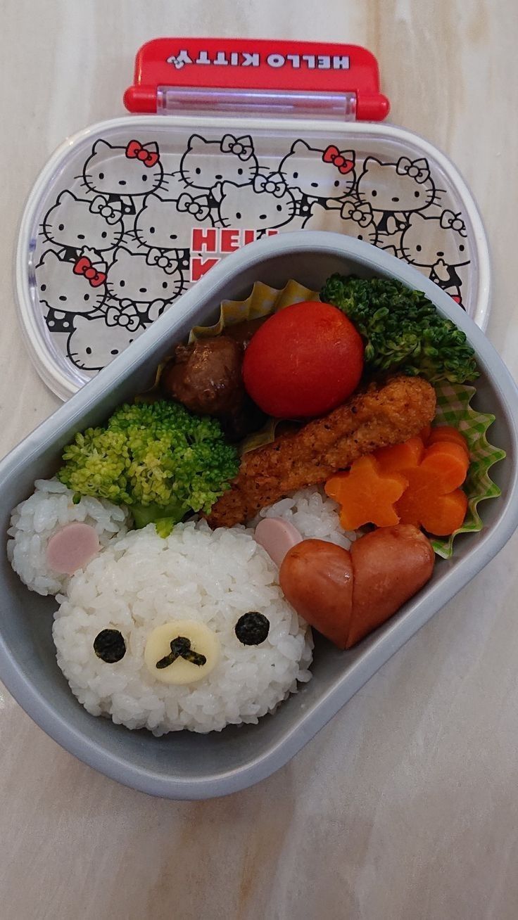 a hello kitty lunch box with rice and vegetables