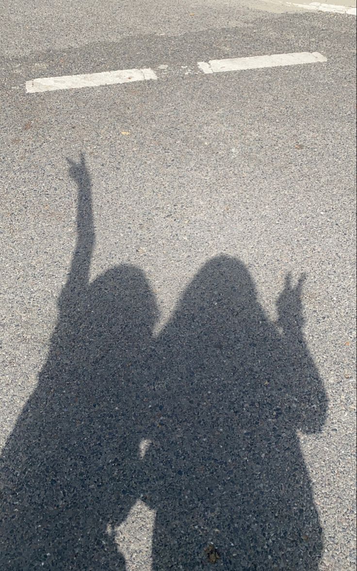 the shadow of a person holding a skateboard