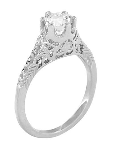 a white gold ring with an intricate design