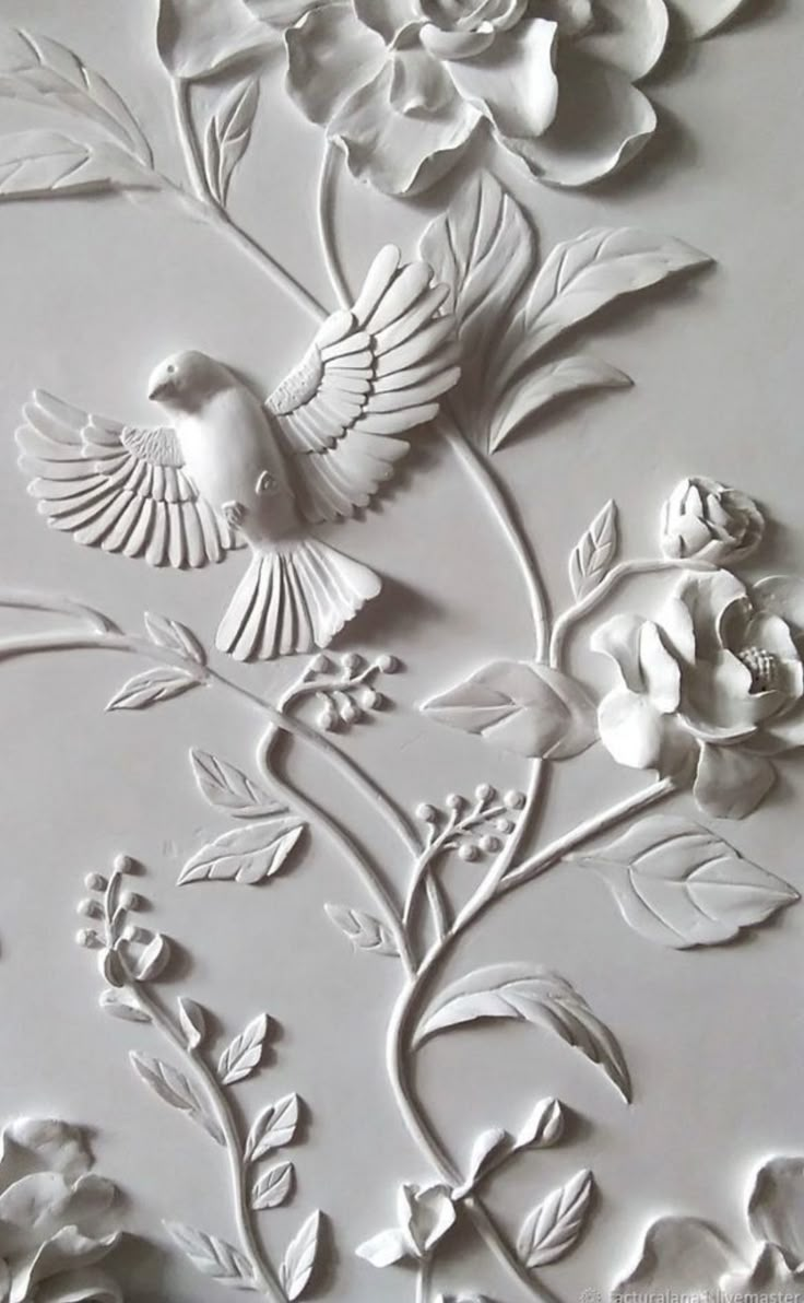 a white wall with flowers and birds on it