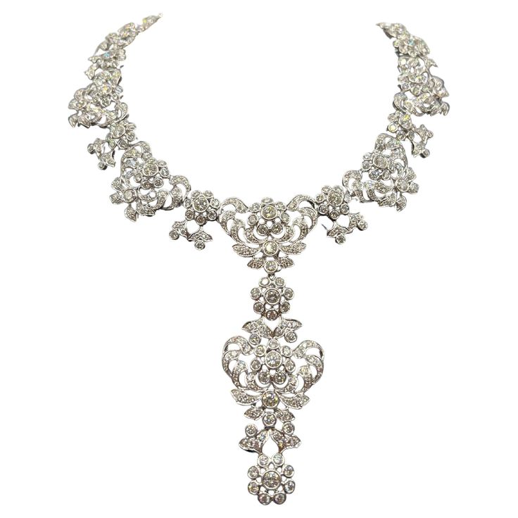 Elevate your jewelry collection with this exquisite Edwardian diamond necklace, meticulously crafted from 18-kt white gold. This custom vintage piece boasts an impressive 35.97-carats of diamonds, radiating timeless elegance and sophistication. The necklace features a detachable centerpiece pendant, allowing versatile styling options to suit any ensemble. Luxury White Gold Diamond Necklace With Intricate Design, Luxury Elegant Filigree Diamond Necklace, Luxury Bridal Necklace In Platinum With Single Cut Diamonds, Luxury Platinum Bridal Necklace With Single Cut Diamonds, Exquisite Diamond Necklace With 17 Jewels For Evening, Platinum Bridal Necklace With 17 Jewels, Exquisite Evening Diamond Necklace, Luxury Diamond White Crystal Necklace, Opulent Diamond Necklace For Formal Events