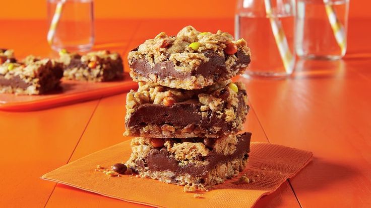 three chocolate bars stacked on top of each other next to some glasses and straws