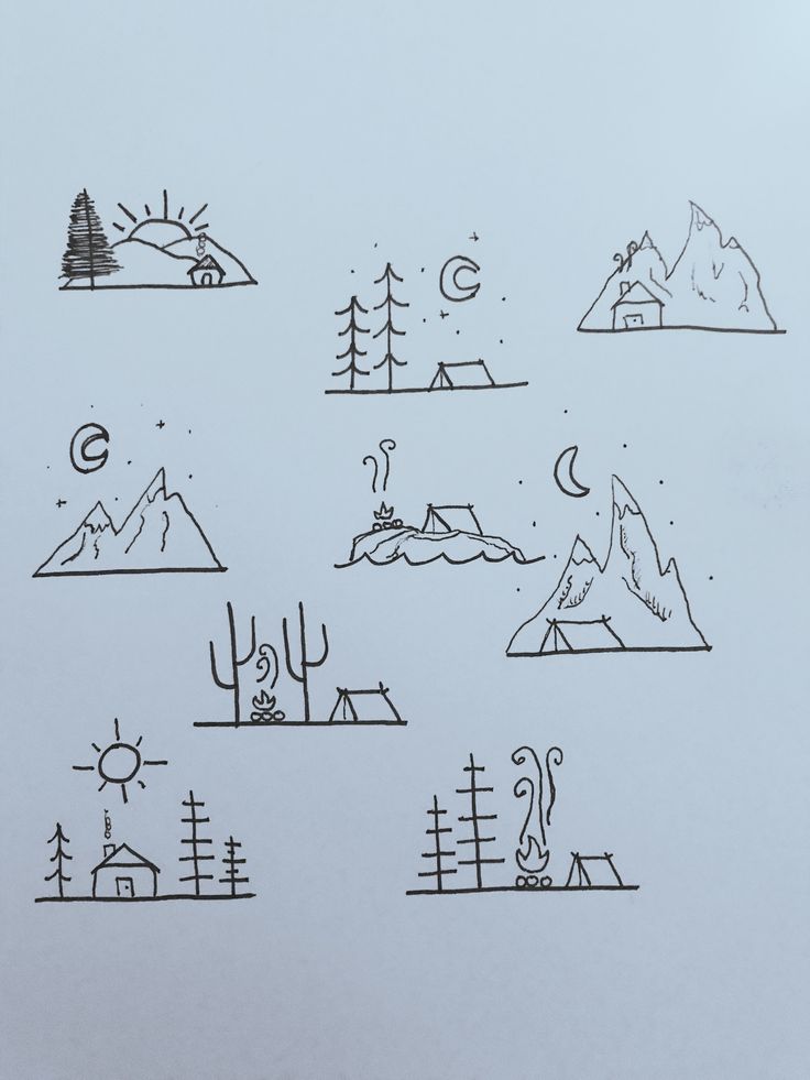 a drawing of mountains and trees on a piece of paper