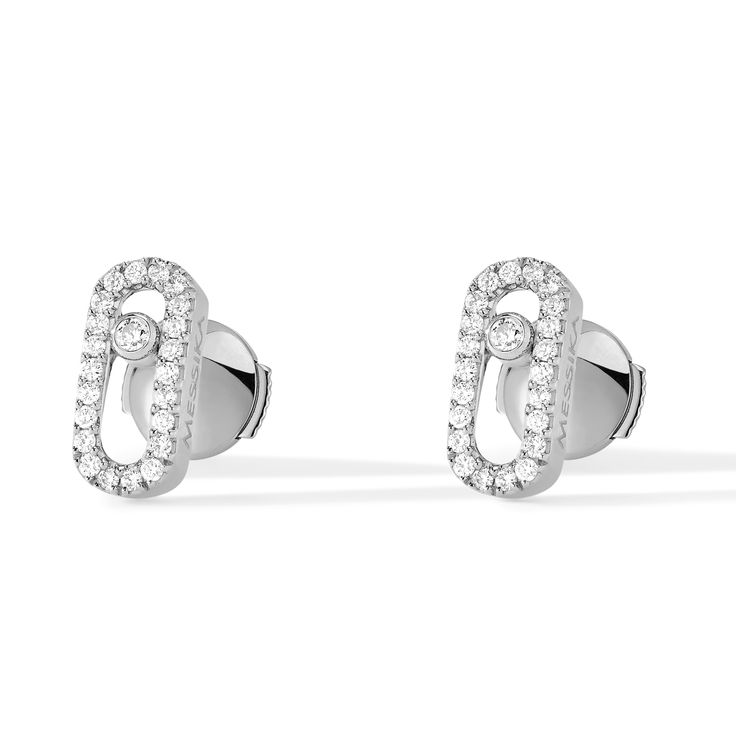 With an elegant and pared down style, these 18k white gold pave diamond earrings set with a brilliant cut diamond are part of the Move jewelry for women collection. Easy to wear everyday in white gold, these diamond earrings suit to any style, from the most casual to the sophisticated ones. This pair of Move Uno white gold diamond stud earrings will become your day to day fetish jewel. Diamonds are 1/5ctw, G in color, and VS in clarity. Messika Style #: 05634-WG Messika Earrings, Messika Move Uno, White Gold Diamond Earrings, Pave Diamond Earrings, Gold Diamond Earrings Studs, Gold Diamond Studs, White Gold Earrings Studs, Gold Diamond Earrings, White Gold Earrings