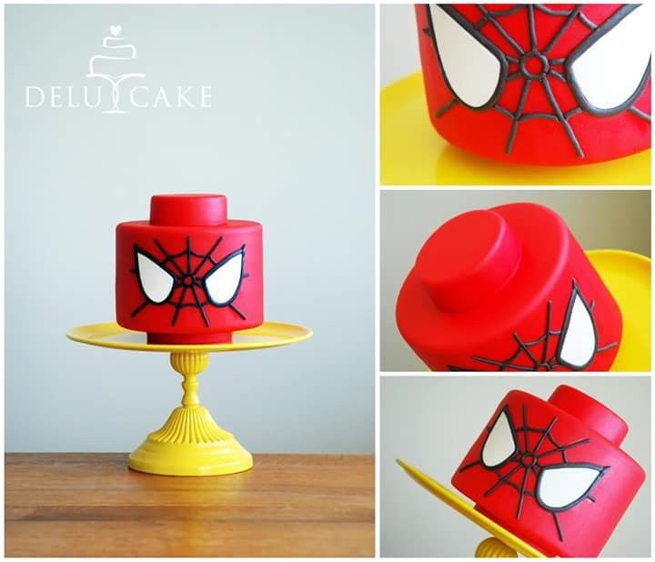 there is a spiderman cake on top of a yellow cake stand and it looks like he's ready to eat the cake