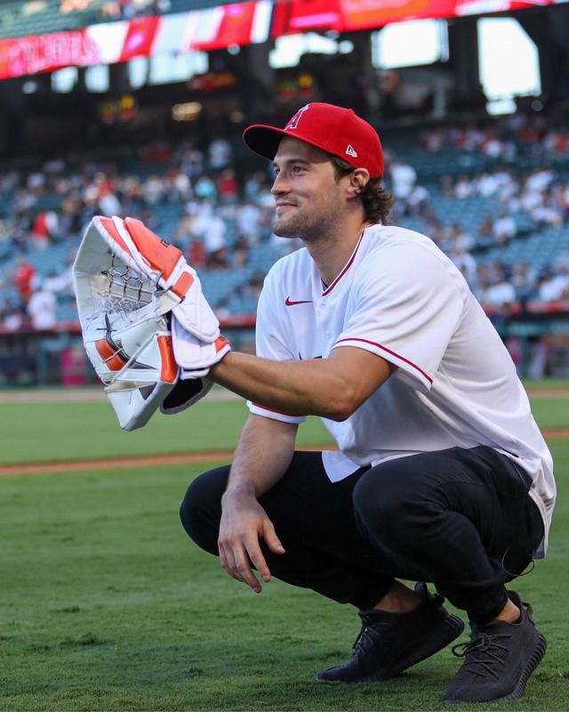 a baseball player kneeling down holding a catchers mitt