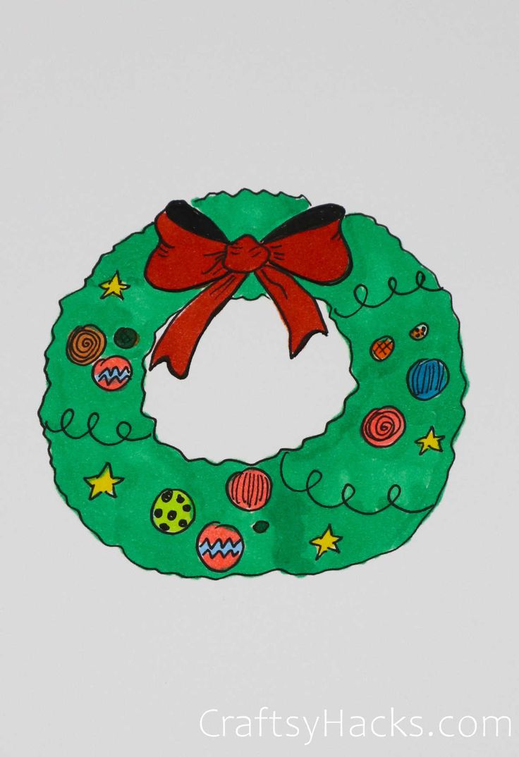 a green wreath with a red bow hanging from it's side on a white wall