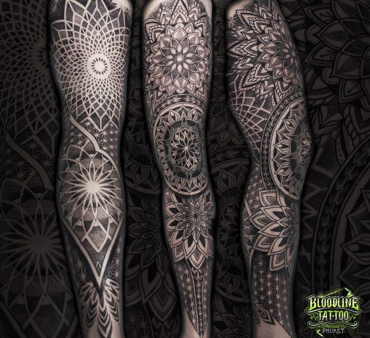 two people with tattoos on their legs and arms, both have intricate designs in them