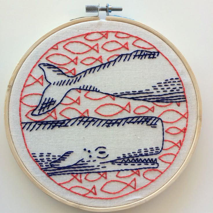 an embroidery pattern with fish and waves on it