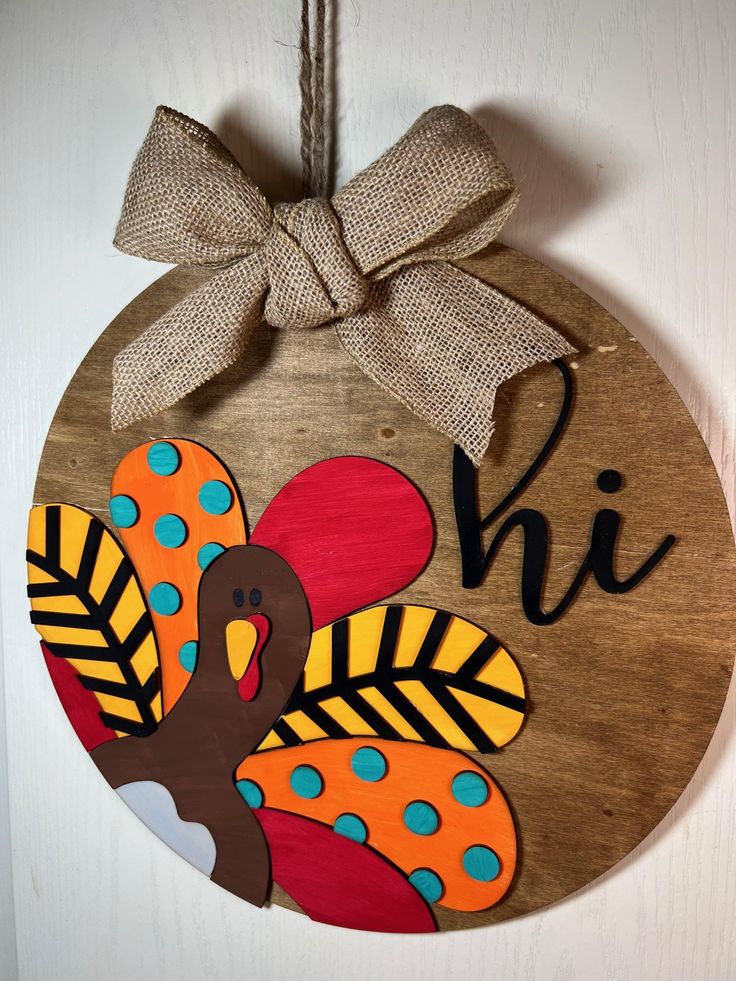 a wooden ornament with a turkey painted on it's face and the word hi