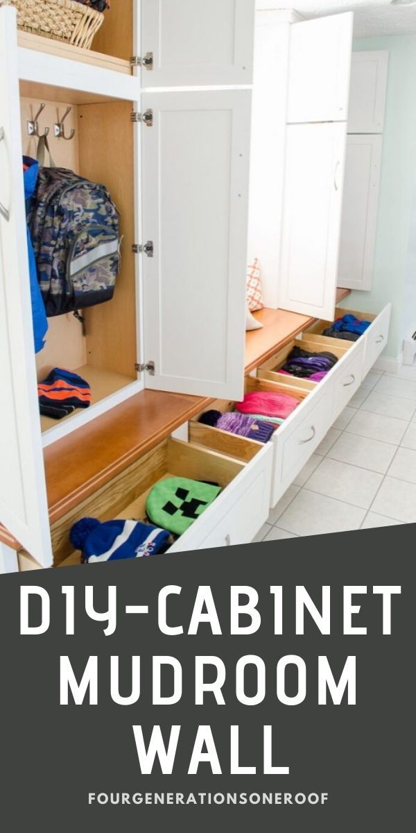 an organized mudroom with white cabinets and drawers