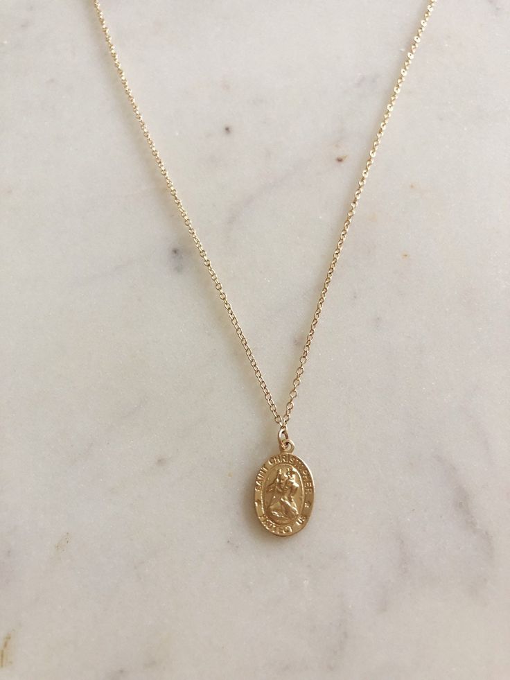 Beautiful for any layering look or gorgeous on its own!  Saint Christopher is widely recognized as the saint of travel. Many people across the world carry this medallion close to protect them on their journeys. Whether you're back packing across the globe, or just making your way home after a long day - be protected by St. Chris!  Gold filled coin and gold filled chain, made to live in!  Measures on 16 inch chain with extender to bring it to 18 inches in order to find your perfect length for lay Gold Medallion Necklace Gift, Saint Christopher Necklace, Back Packing, St Christopher Necklace, Layered Coin Necklace, Travel Necklace, Saint Christopher, Necklace Layering, Coin Necklace