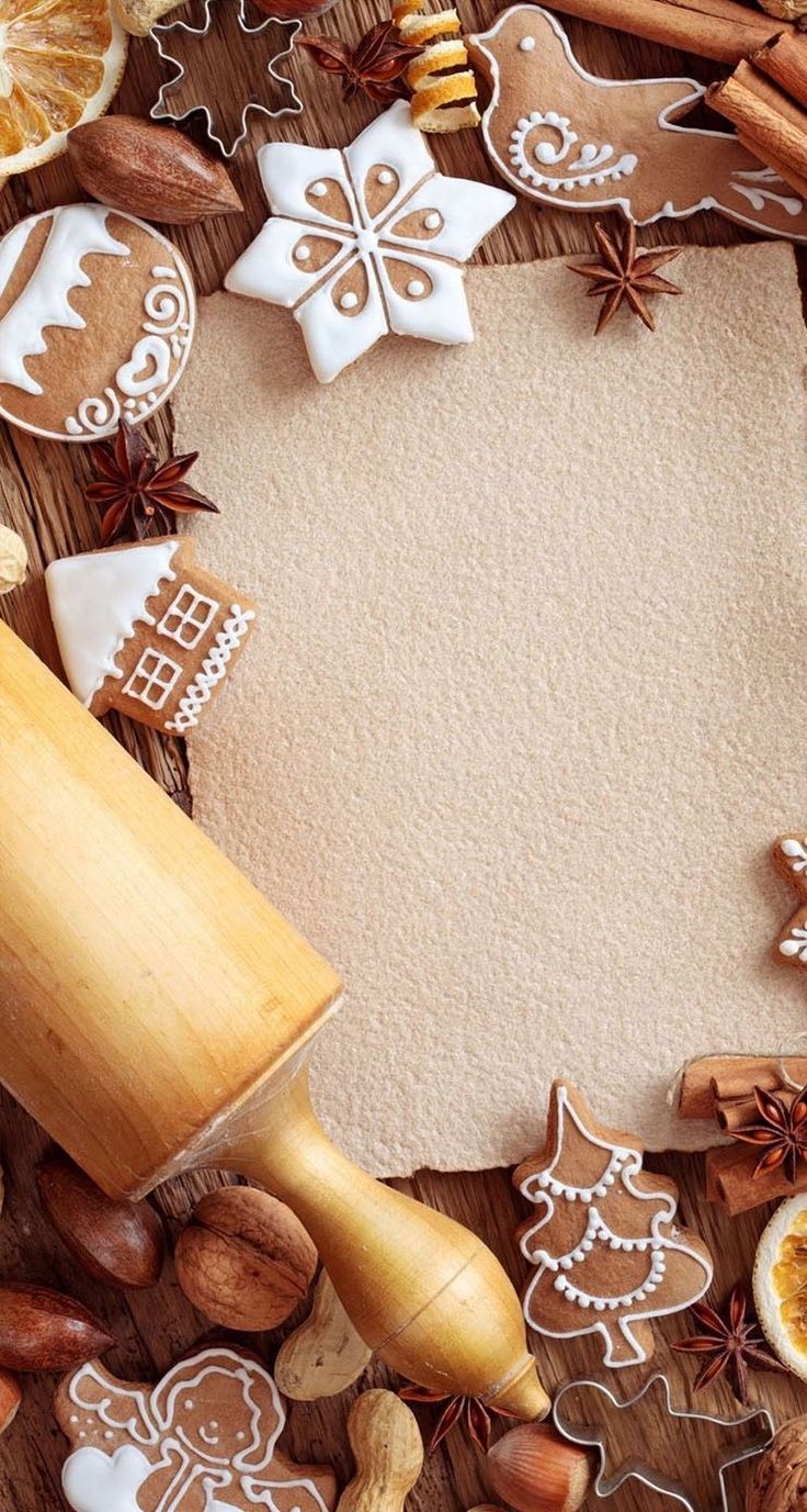 an assortment of cookies, nuts and other food items on a wooden surface with a blank space in the middle