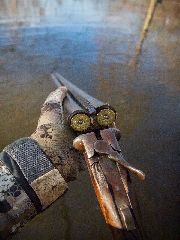 an old pair of scissors sitting on top of a wooden pole in the middle of water