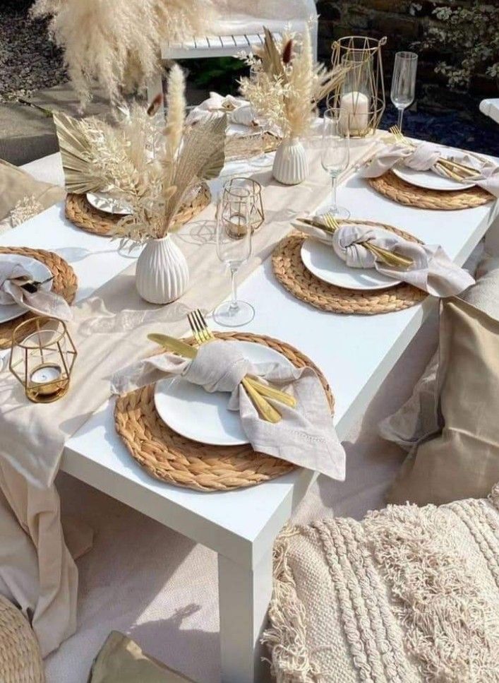 a table set with plates, napkins and place settings for an outdoor dinner party