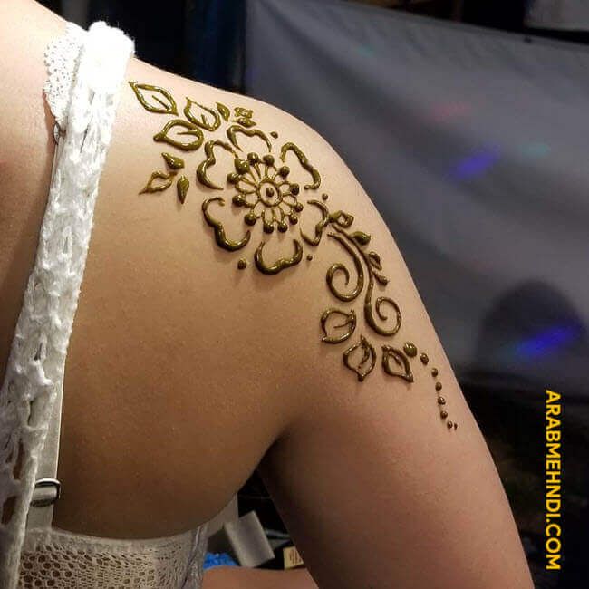 the back of a woman's shoulder with henna tattoos