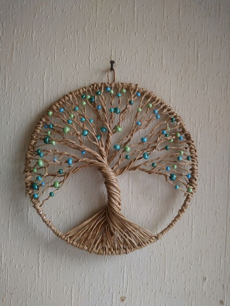 a wicker tree with blue and green beads