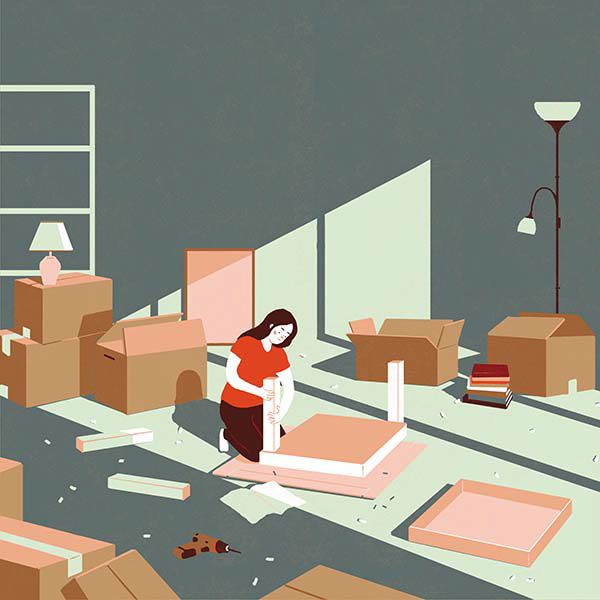 a woman standing in a room filled with boxes and other items that have been placed on the floor