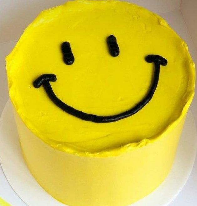 a yellow cake with a smiley face on it