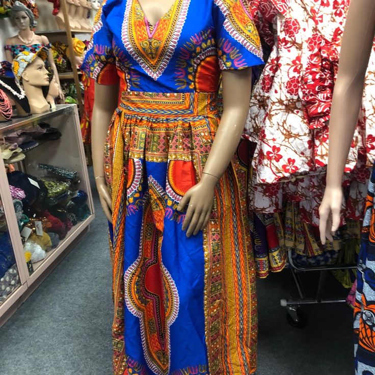 African Clothing For Women Danshiki Ankara Print Handmade Long Dress. Blue Background Mannequin Is Wearing. Size 10 Contact Me For Questions About This Dress V-neck Batik Print Festival Dress, Bohemian Blue Dress With Colorful Pattern, Blue Bohemian Dress With Colorful Pattern, Blue V-neck Dress With Vibrant Print, Traditional Multicolor V-neck Maxi Dress, Bohemian Blue Dresses With Vibrant Print, Bohemian Royal Blue Maxi Dress, Bohemian Blue Dress With Vibrant Print, Blue Bohemian Dress With Vibrant Print