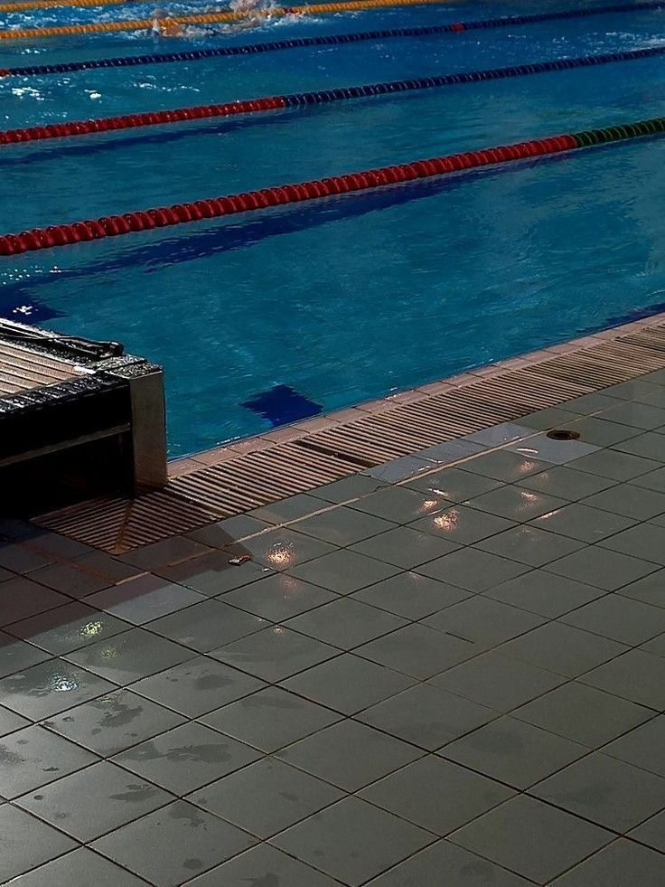 an empty swimming pool with swimmers in it