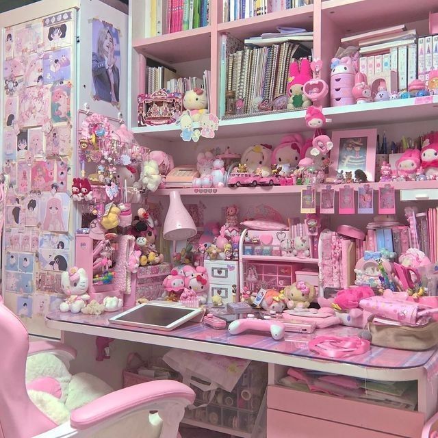 a room filled with lots of pink furniture and toys on top of a wooden table