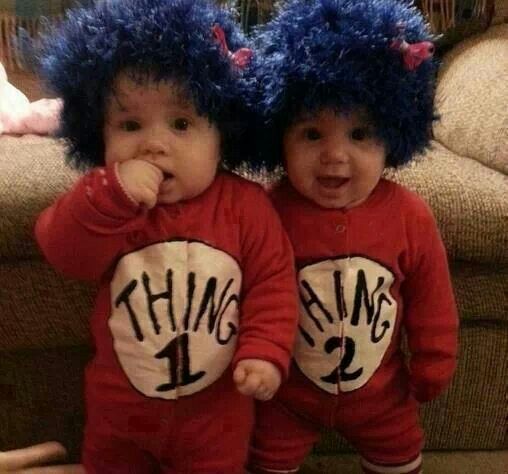 two babies wearing matching outfits with blue hair