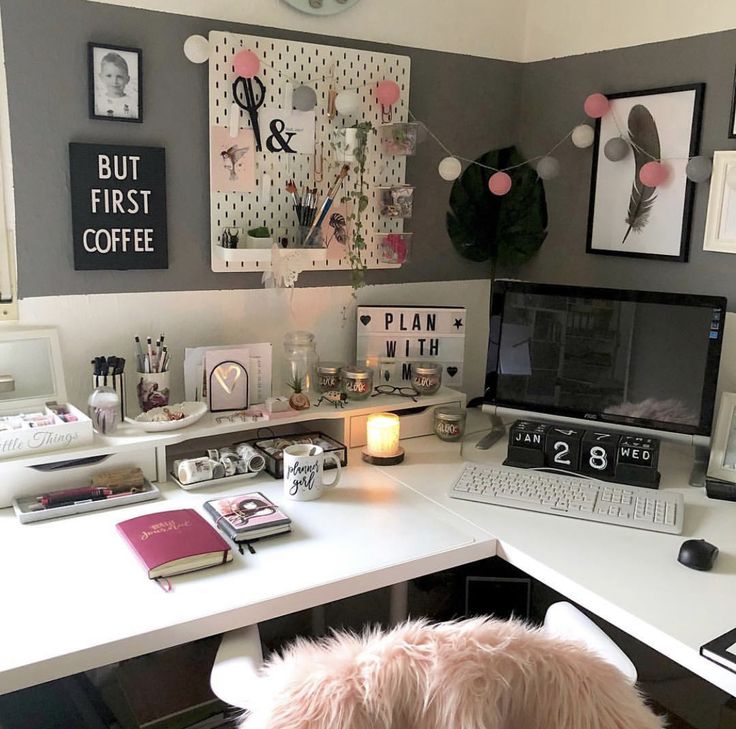 a white desk topped with a laptop computer and a pink dog sitting next to it