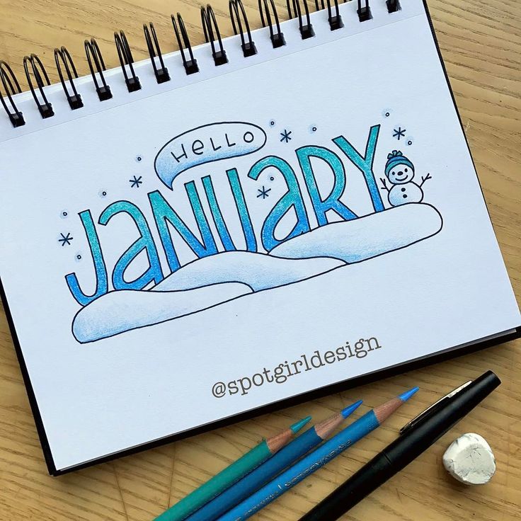 a notebook with the word january written on it next to some pencils and crayons