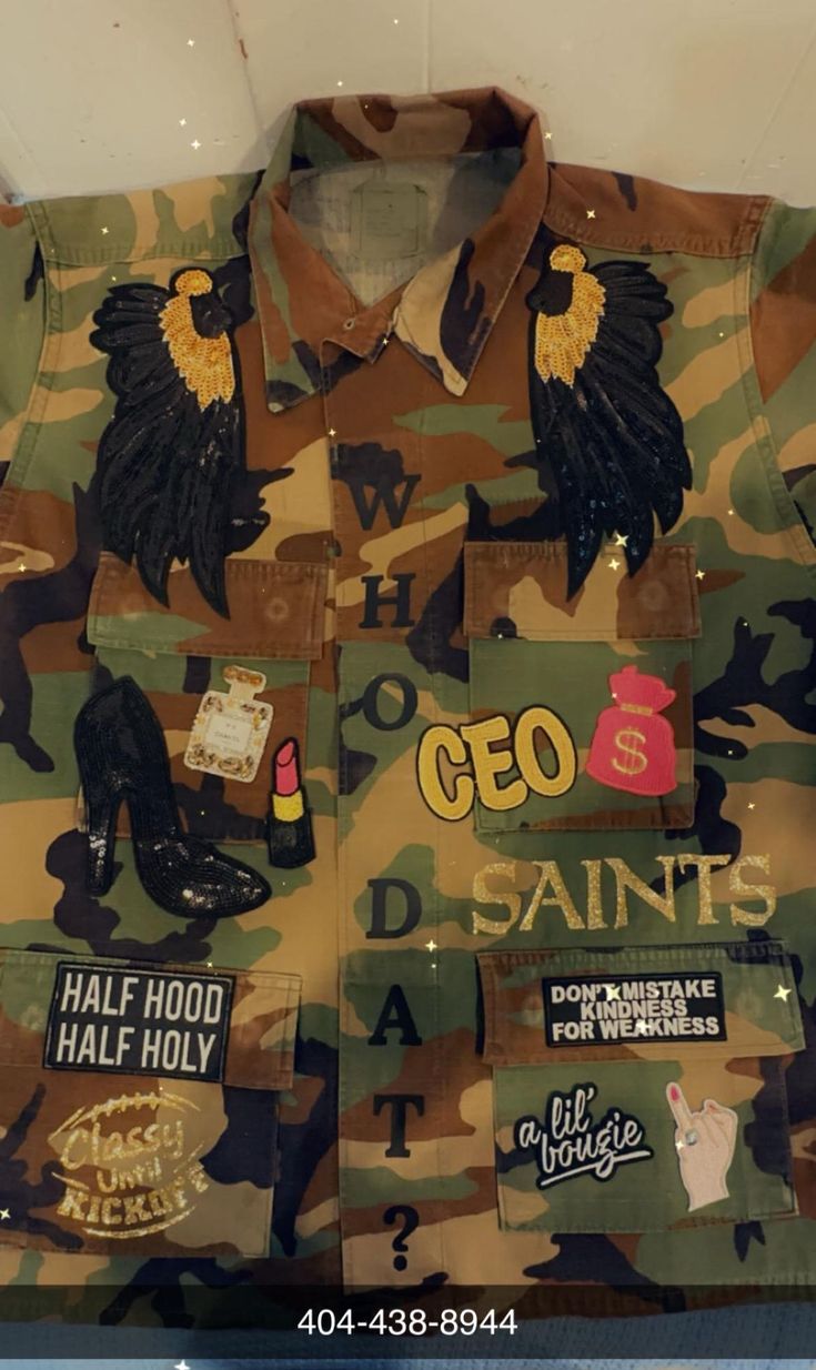 a camouflage shirt with patches and stickers on it