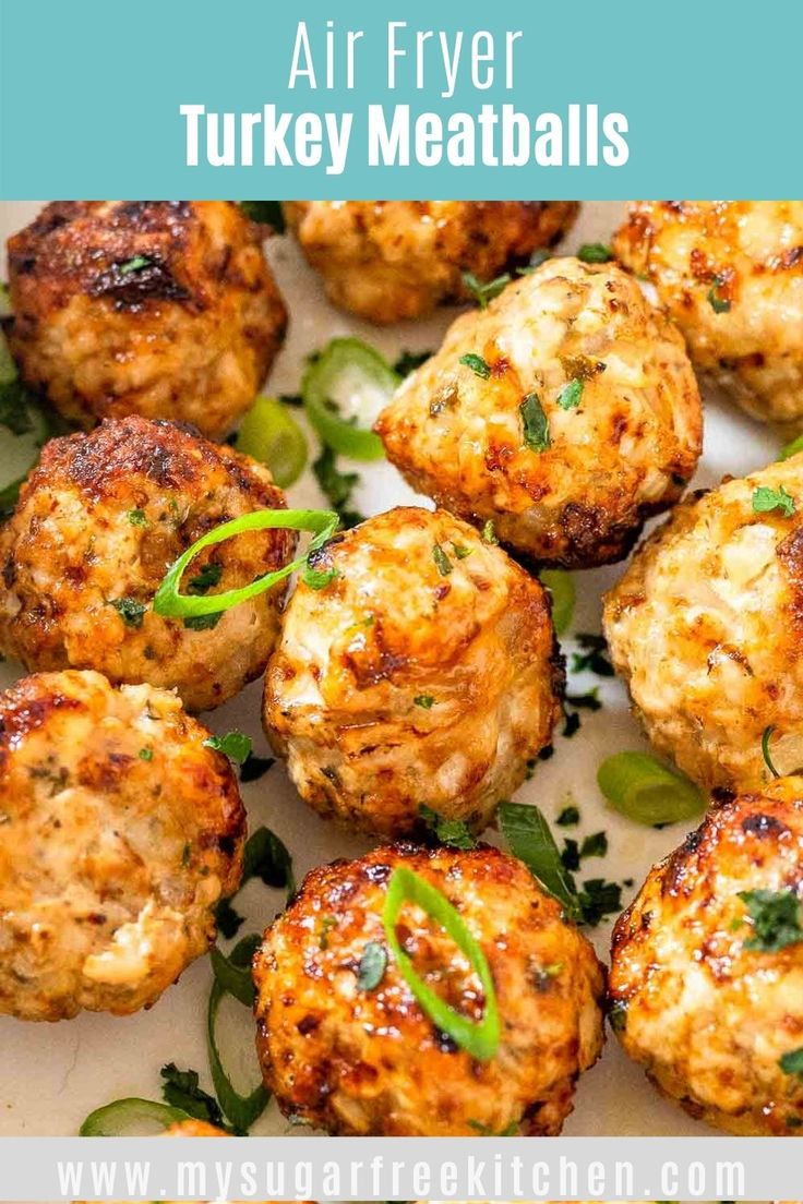 air fryer turkey meatballs on a white plate with green garnishes