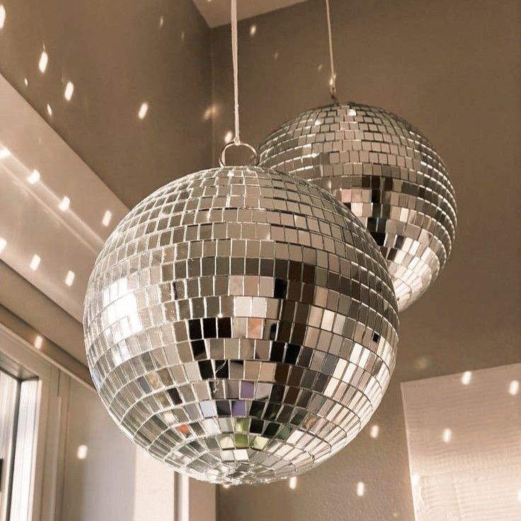 two disco ball lights hanging from a ceiling