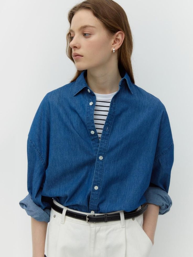 This is DEPOUND’s oversized fit denim shirt. Made of lightweight and soft material, it's versatile for styling with any look. With its loose fit silhouette and natural color tones, it can be comfortably worn without feeling constrained. It's a basic item suitable for wearing throughout the seasons, great for wearing alone or as a light outer layer in the warmer seasons.- It's a great item for daily wear- You can pair it with different styles of bottoms to create various looks- Detailing with the D-Foundation logo embroidery on the waist adds a stylish touch Relaxed Fit Light Wash Shirt For Workwear, Light Indigo Relaxed Fit Denim Top For Everyday, Oversized Dark Wash Shirt For Spring, Everyday Relaxed Fit Light Indigo Denim Top, Light Indigo Denim Shirt For Everyday, Relaxed Fit Denim Tops, Everyday Light Indigo Relaxed Fit Denim Top, Classic Medium Wash Tops For Everyday, Oversized Cotton Denim Top For Everyday Wear