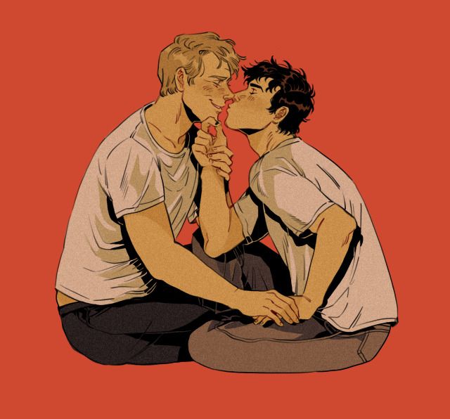 two young men sitting on the ground kissing each other with red walls in the background