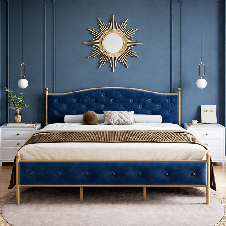 a bed with blue upholstered headboard and gold accents in a bedroom setting