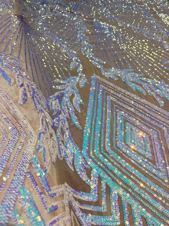 an intricately designed piece of cloth with blue and gold sequins on it