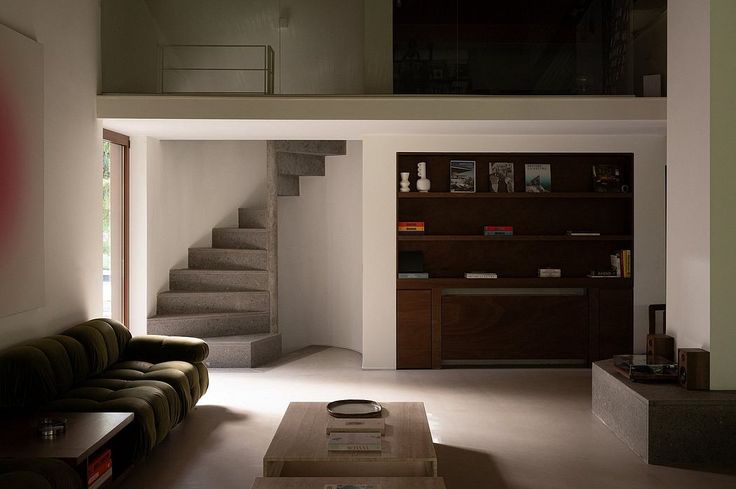 a living room filled with furniture and a staircase