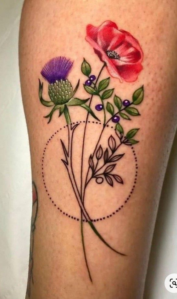 a tattoo with flowers on the thigh and an arrow in the middle, is shown