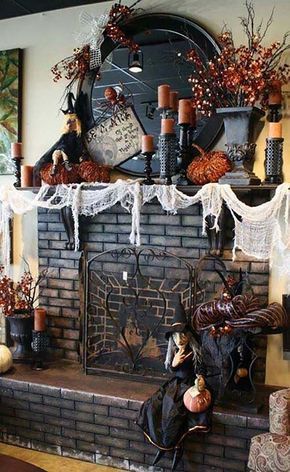 a fireplace decorated for halloween with candles and decorations