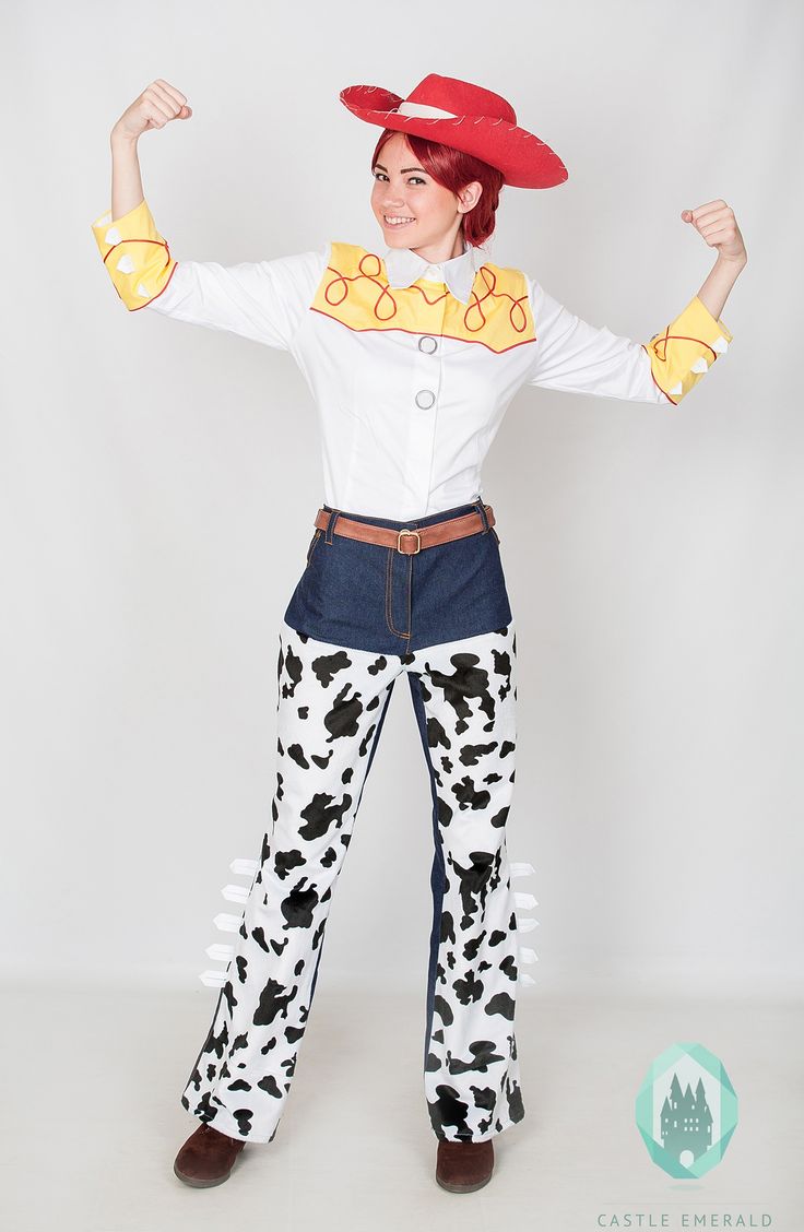 a woman dressed up as a cowgirl with her arms in the air