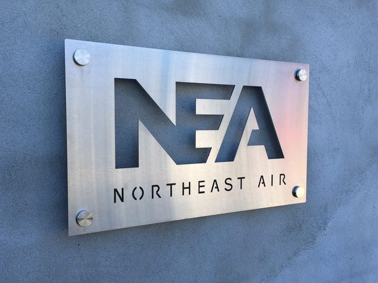 a metal sign on the side of a building that says nea north east air