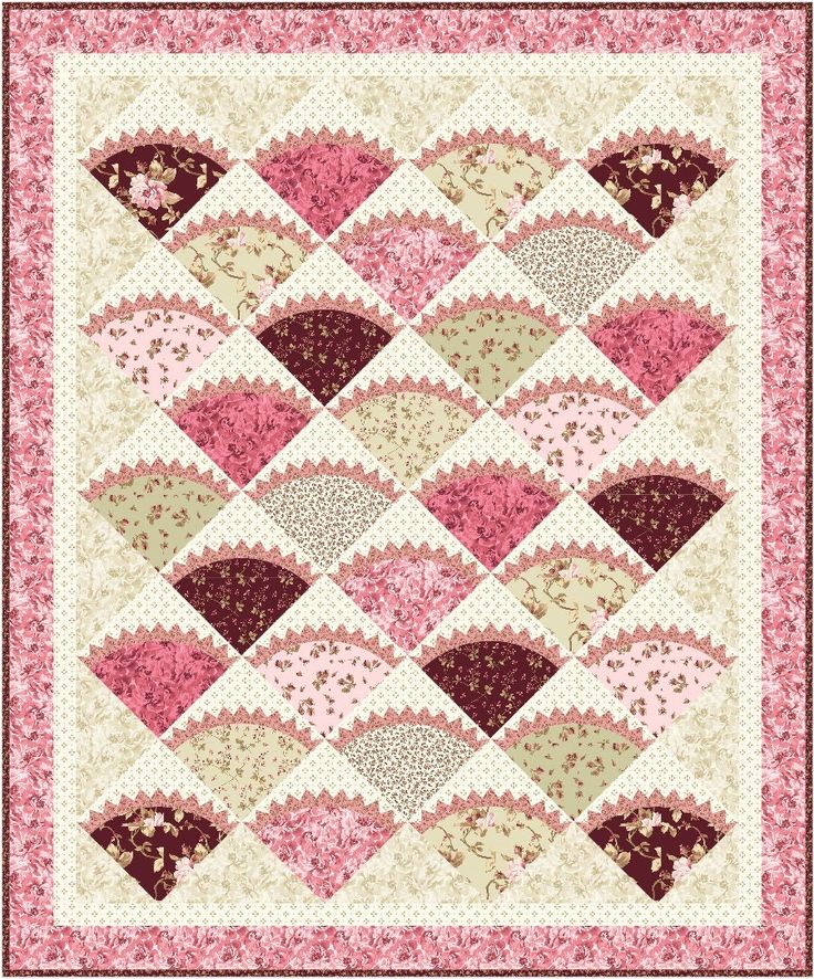 a pink and beige quilt with hearts on it's sides, in the center