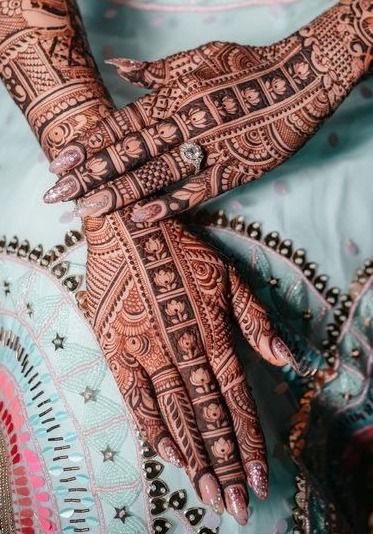 the hands of a woman are decorated with henna