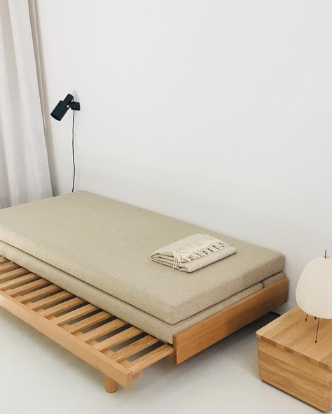 a bed with a mattress on it next to a night stand