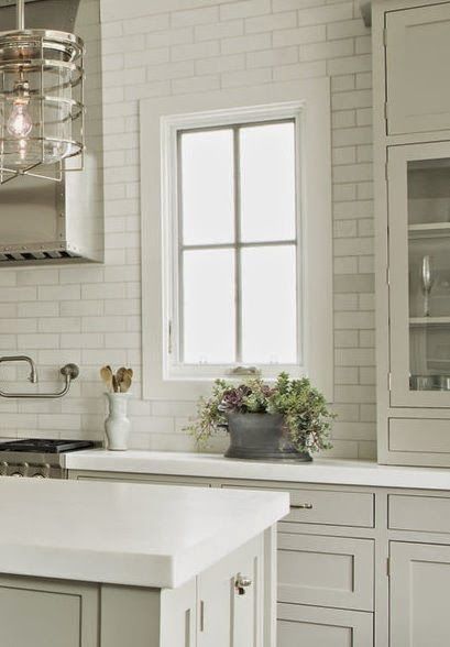 a kitchen with white cabinets and an island