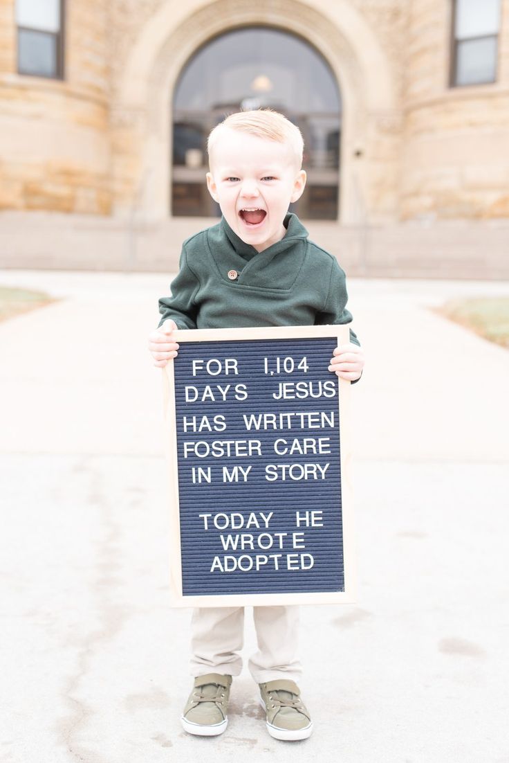 a little boy holding a sign that says for 10 days jesus has written foster care in my story