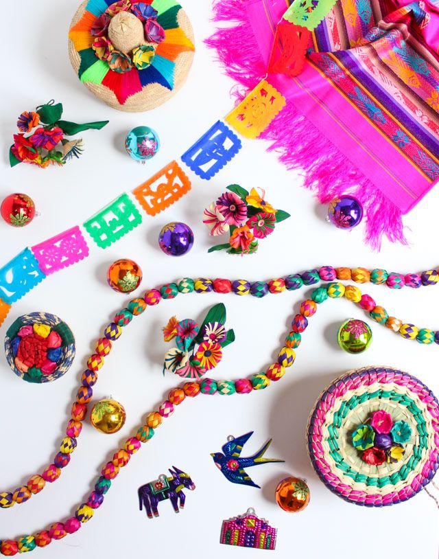 colorful beads and decorations are laid out on a white surface, including an ornament