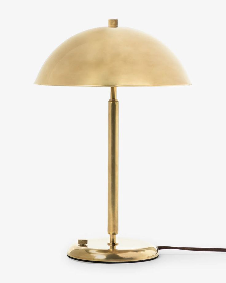 a lamp that is on top of a white surface with a cord attached to it