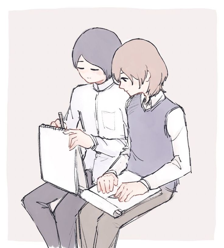 two people are sitting on a chair and one person is writing something in a notebook