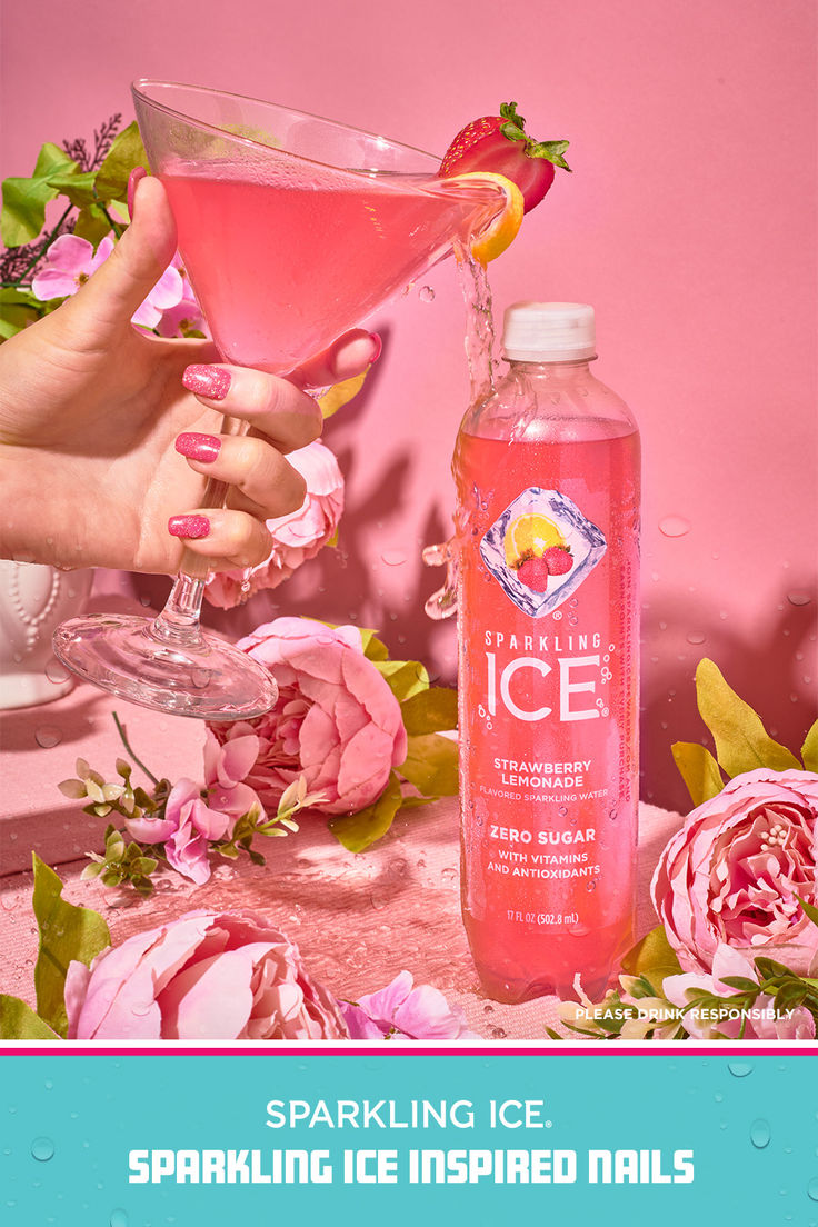 a woman holding a pink drink next to a bottle of sparkling ice inspired nails with flowers on the table